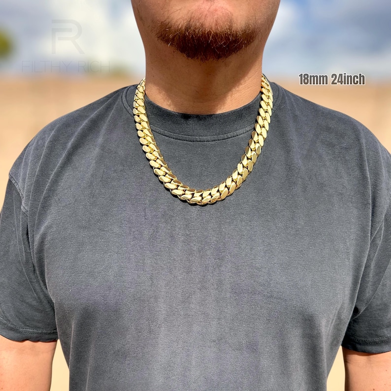 Man wearing an 18mm 24-inch Miami Cuban link chain in natural sunlight, showing the bold gold shine and tight link design.