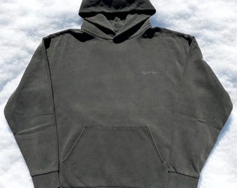 May include: A dark green hooded sweatshirt with a small "SUNNY RICH" logo on the front. The sweatshirt has a kangaroo pocket and long sleeves.