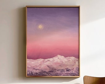 May include: A framed painting of a snowy mountain range under a pink and purple sky with a full moon. The painting is hanging on a white wall next to a wooden chair.