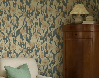 May include: Wallpaper featuring a repeating pattern of dandelion seed heads and thistle-like flowers in muted orange and dark blue-green on a light beige background, positioned behind a cream-colored armchair with a green pillow.