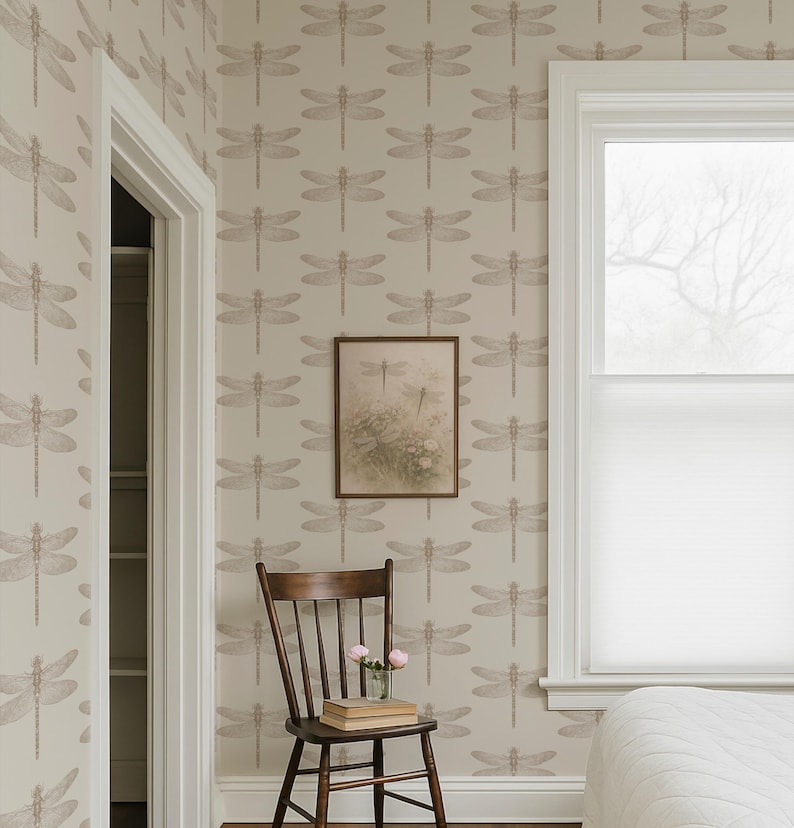 a serene bedroom scene with a wooden chair, a white bed, and a framed picture of a dragonfly on the wall.