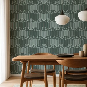 a modern dining room with a wooden table and chairs, a patterned wallpaper, and two pendant lights hanging above the table.