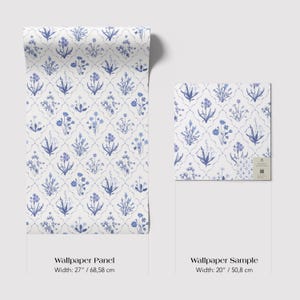 May include: A roll of wallpaper and a sample, both featuring a repeating pattern of blue floral designs on a white background. The wallpaper panel is 27 inches wide, and the sample is 20 inches wide. The design includes various flower and leaf motifs.