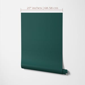 Wallpaper roll 27 inches wide of a solid color wallpaper in dark green.