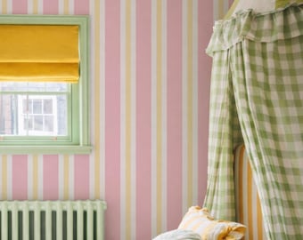 May include: A child's bedroom with pink, yellow, and white striped wallpaper. A yellow window shade and green window frame are visible. A bed with a green and white gingham canopy and pillows is in the foreground. Stuffed animals are on the bed.