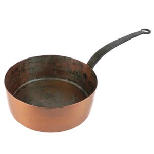 May include: A copper saucepan with a long, dark metal handle. The pan has a rounded shape and a slightly worn interior. The exterior is a shiny copper color, and the handle has a loop at the end for hanging.
