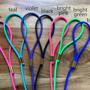 May include: Eight colorful cords with gold accents. The cords are teal, violet, black, bright pink, bright green, and blue.