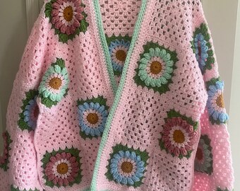 Crocheted cardigan with 3d flower squares size 12/14 approximately.