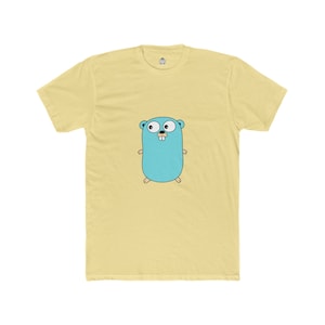 May include: A light yellow t-shirt featuring a cartoon gopher in light blue. The gopher has large eyes and small arms and legs. The shirt has a small logo on the upper back.