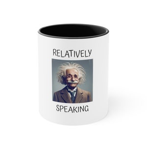 May include: White ceramic mug with a black interior rim. The mug features a portrait of Albert Einstein with the words "RELATIVELY SPEAKING" printed above and below the image. The mug is a novelty item.