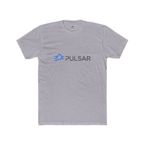 May include: A grey t-shirt featuring the word "PULSAR" in dark grey, with a blue wave design above it. The shirt has short sleeves and a crew neck.