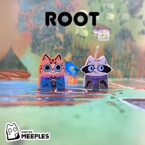 May include: Two wooden game pieces from the board game "Root", featuring an orange cat and a raccoon. The cat has large blue eyes and a blue shirt. The raccoon wears glasses and a purple scarf. The word "ROOT" is printed in large black letters.