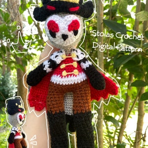 May include: A crocheted plush toy of Stolas from the show Helluva Boss. The toy is wearing a black hat with a gold crown, a red and white waistcoat, brown trousers, and black boots. The toy is holding a red cape in its hands. The text "Stolas Crochet Digital Pattern" is written on the image.