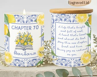 May include: Two cylindrical candles with blue and white tile-patterned borders and yellow lemon illustrations. One candle features the text "CHAPTER 70" and "Barbara" above an open book with flowers. The other displays a poem and a wooden lid.
