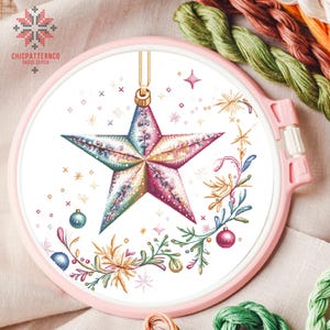 May include: A colorful star-shaped Christmas ornament with a floral design and a white background. The ornament is surrounded by small stars and dots.
