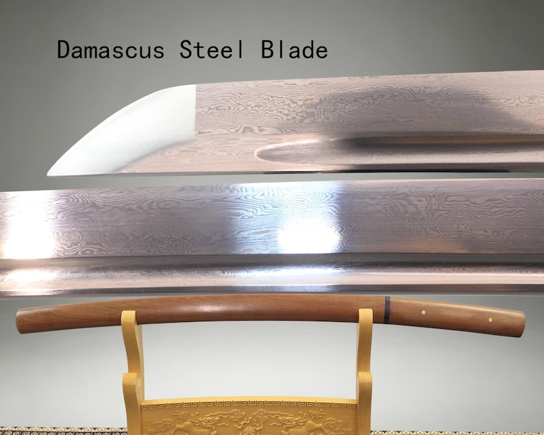 May include: A Damascus steel blade with a visible wavy pattern and a sharp edge, positioned above a wooden sword scabbard resting on a light-colored stand. The text "Damascus Steel Blade" is printed in black in the upper left corner of the image.