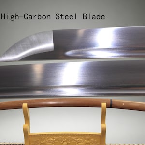 May include: A high-carbon steel blade with a polished metallic finish and a curved edge, positioned above a smooth, light brown wooden scabbard resting on a light-colored wooden stand. The text High-Carbon Steel Blade is visible above.