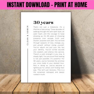 May include: A white print with the text "30 years" and a message about recovery and growth. The print includes the words "Clean & Sober" and "Instant Download - Print at Home". The print is on a wooden surface.
