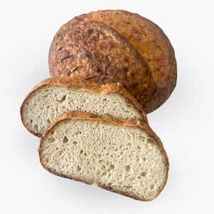 May include: A loaf of freshly baked bread sliced in half, revealing a light brown, airy crumb. The bread has a golden brown crust and a slightly irregular shape.