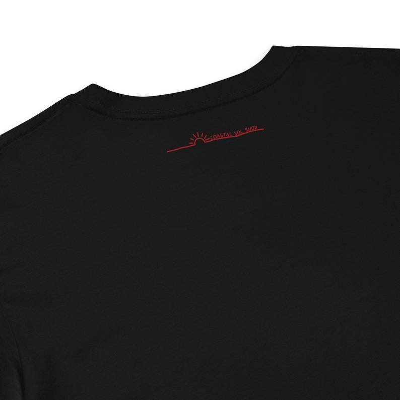 May include: Black t-shirt with a red sun and the text "Coastal For Good" on the back.