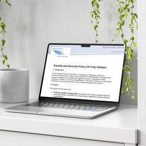 May include: A laptop computer displaying a document titled "Equality and Diversity Policy UK Fully Editable". The document outlines the company's commitment to creating a respectful and inclusive work environment for all employees.