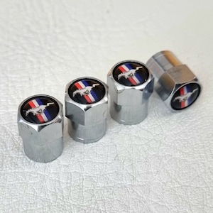 May include: Set of four silver tire valve stem caps with a black and red Mustang logo.