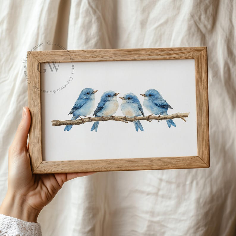 May include: A framed watercolour painting of four bluebirds perched on a branch. The birds are facing to the right and have light blue bellies and darker blue wings and tails.