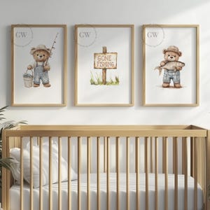 May include: Three watercolor illustrations of a brown teddy bear in a blue overall. The first image shows the bear holding a fishing rod and a bucket of fish. The second image shows a sign that says "Gone Fishing". The third image shows the bear holding a fish.