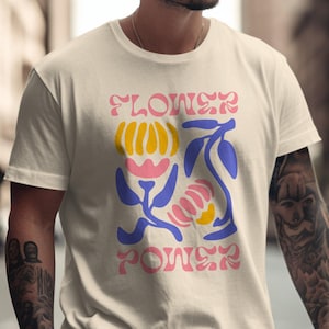 レトロなフラワーパワーグラフィックTシャツ、70年代風フローラルTシャツ、ヴィンテージヒッピーシャツ、グルーヴィーなサマートップス、フェスティバルファッション、ボヘミアンシック
