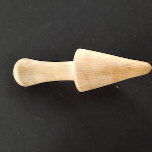 May include: A wooden ice cream scoop with a rounded handle and a pointed tip.