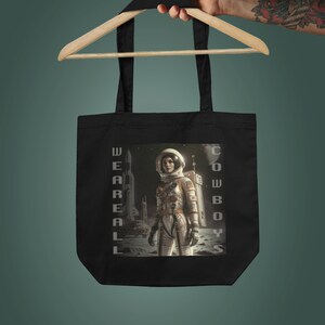 女性宇宙飛行士エコトートバッグ | スペースカウボーイズショッパー | ギャラクシーショッピングバッグ | 100%コットンキャンバストート | 激しい宇宙旅行者グラフィック
