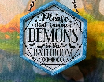 Blue and white 'Please Don't Summon Demons in the Bathroom' resin wall hanging, hexagonal