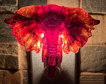 Elephant Nightlight, warm reds and oranges, iridescent flakes shine during the day, handmade from resin, plugs into standard outlet