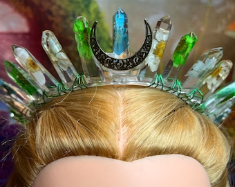 Real leaves & flowers encased in resin crown, mostly neutral palette colors and splashes of blue, with green colored wire and accent