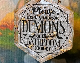 Black, white and gold 'Please Don't Summon Demons in the Bathroom' resin wall hanging with lots of chunky gold metallic flakes, hexagonal