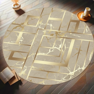 May include: A round area rug featuring a beige marble-like texture with a prominent gold geometric pattern consisting of intersecting lines and squares. The design creates a layered effect across the surface, blending soft neutral tones with metallic gold.
