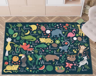 May include: A dark teal children's rug featuring an illustrated alphabet with animals and fruits. Each letter is paired with a corresponding animal or fruit, such as 'A' for avocado and 'B' for banana. The design includes a toucan, tiger, and zebra.