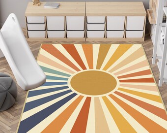 May include: A rectangular area rug featuring a central solid mustard yellow circle surrounded by radiating sunburst stripes in alternating shades of navy blue, teal, orange, mustard yellow, and cream, creating a geometric pattern across the surface.