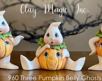 May include: Three ceramic ghost figurines with pumpkin bellies. Each ghost has a different pose and facial expression. The ghosts are painted in white, orange, and green. The text "Clay Magic Inc." is visible in the background.