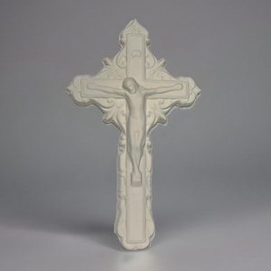 May include: White ceramic wall crucifix with a detailed design and a figure of Jesus Christ.