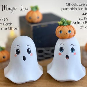 May include: Two white anime ghost figurines, each with a surprised expression, are featured in this image. One ghost has a small orange pumpkin on its head. The text on the image says "4.5" Anime Ghost" and "2" x 2" Anime Pumpkin".
