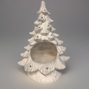 May include: White ceramic Christmas tree with a hollow centre and a textured surface. The tree has a base with a leaf design.