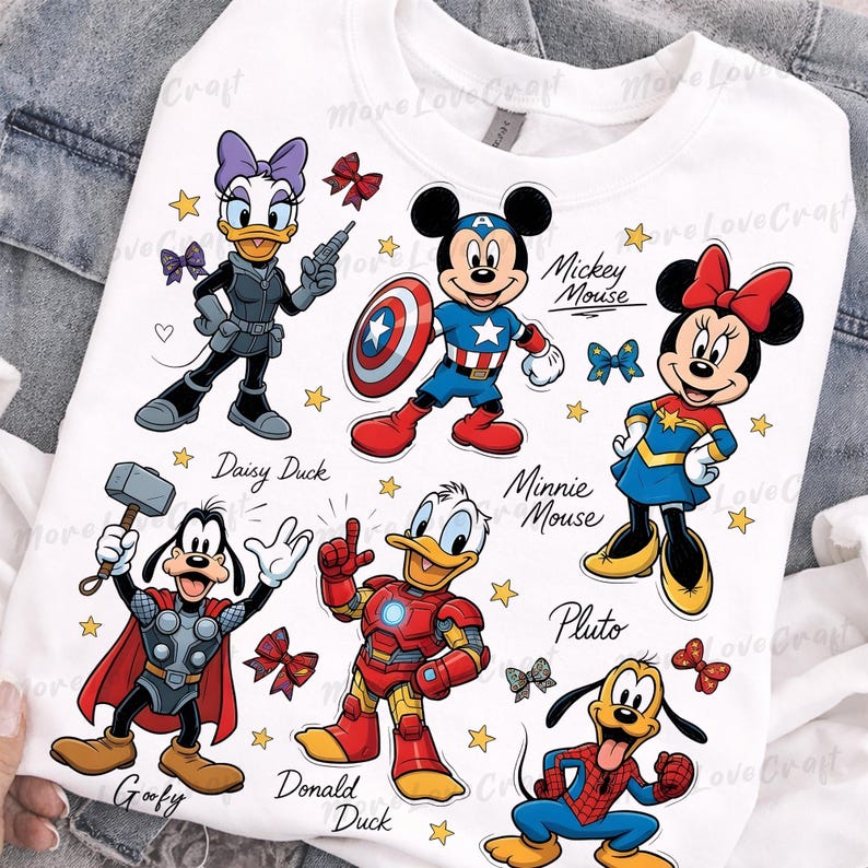 May include: White sweatshirt featuring cartoon characters Daisy Duck, Mickey Mouse, Minnie Mouse, Goofy, Donald Duck, and Pluto dressed as superheroes. The design includes stars, bows, and character names. The text "More Love Craft" is also visible.