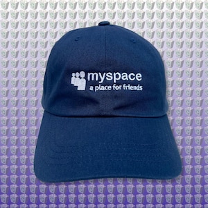 May include: A navy blue baseball cap with white embroidery that reads "myspace a place for friends".