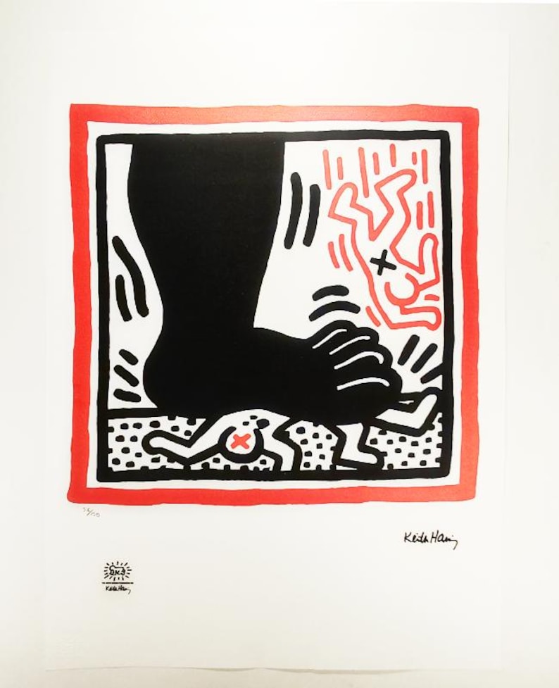 May include: A black and red print of a large foot stepping on a smaller figure. The print is framed in a red border and signed "Keith Haring" in the bottom right corner.