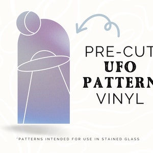 May include: Pre-cut UFO pattern vinyl for stained glass projects. The design features a UFO with a dome and a beam of light. The pattern is on a gradient background of purple and blue.