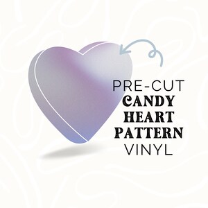 May include: A pre-cut candy heart pattern vinyl decal. The decal is shaped like a heart and has a gradient of purple and blue colors. The text "PRE-CUT CANDY HEART PATTERN VINYL" is written below the heart.