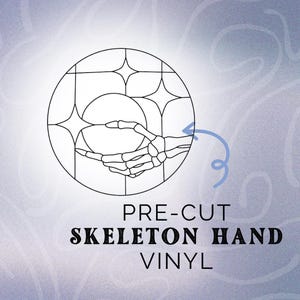 May include: A black and white line drawing of a skeleton hand inside a circle with stars. The text "PRE-CUT SKELETON HAND VINYL" is below the circle.