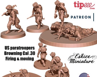 May include: A set of six 3D printed miniature figures of US paratroopers in various poses, including firing a Browning Cal. 30 machine gun. The figures are painted in a brown color and are standing on circular bases. The text "US paratroopers Browning Cal. 30 Firing & moving" and "Eskiçe Miniature" are visible in the image. The image also includes the text "tipee.com" and "PATREON".