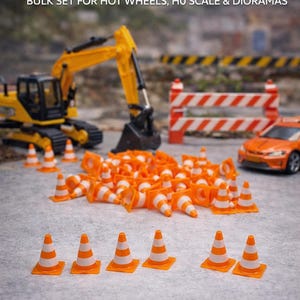 May include: Miniature orange and white traffic cones, perfect for model displays. The image shows a bulk set of cones, with a yellow excavator, an orange car, and a road barrier in the background. Text on the image reads "MINI TRAFFIC CONES" and "BULK SET FOR HOT WHEELS, HO SCALE & DIORAMAS."